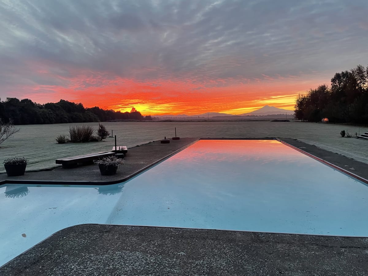 Amanecer sobre el parque y la piscina, con vista a la cordillera